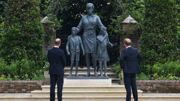 Princes William and Harry put aside their differences to appear together Thursday to unveil a statue honoring their mother Diana in the Sunken Garden of Kensington Palace. — Courtesy photo