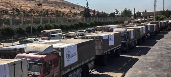 Trucks carrying food assistance cross the Turkish border into Syria. —File photo
