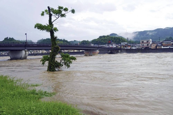 Water levels surge in the Sendai River in the town of Satsuma, Kagoshima Prefecture, on Saturday morning. — courtesy Kyodo