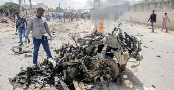 
Security forces and civilians gather near the wreckage after a suicide car bomb attack that targeted the city's police commissioner in Mogadishu, Somalia, Saturday. — courtesy photo