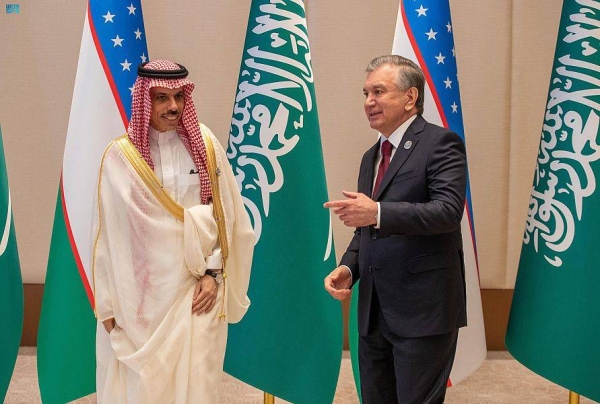 Saudi Arabia’s Foreign Minister Prince Faisal Bin Farhan, left, is seen with President of Uzbekistan Shavkat Mirziyoyev in Tashkent on Friday. 