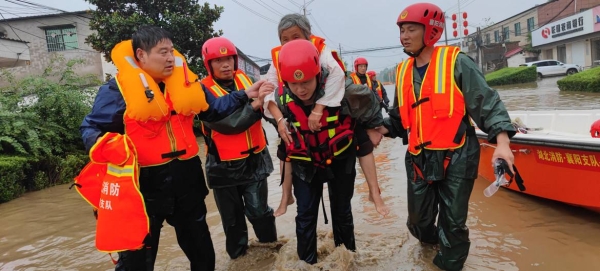Rescuers pull villagers from flood waters in Xingyang city in China's Henan Province. — Courtesy photos
