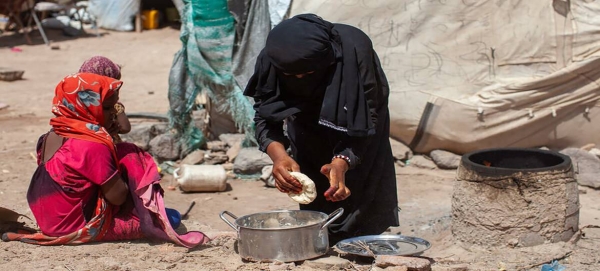 A seven-year-old girl watches as her mother make bread in Mokha, Yemen. — Courtesy file photo