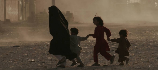 A family runs across a dusty street in Herat, Afghanistan. — Courtesy file photos