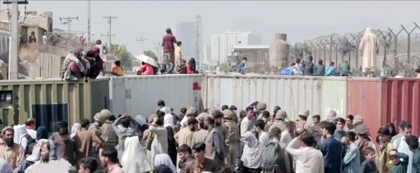 Fleeing Afghanis mill around the Kabul airport in a desperate bid to fly out of the country.