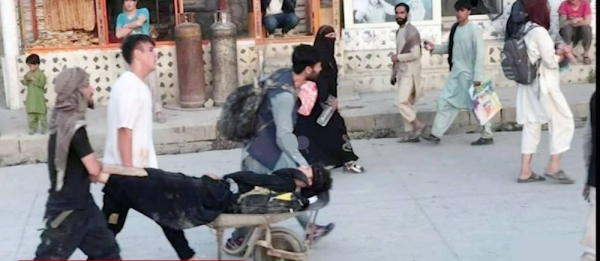 Videograb of Afghanis rushing the injured in wheelbarrows for aid following two explosions outside the Kabul airport on Thursday.