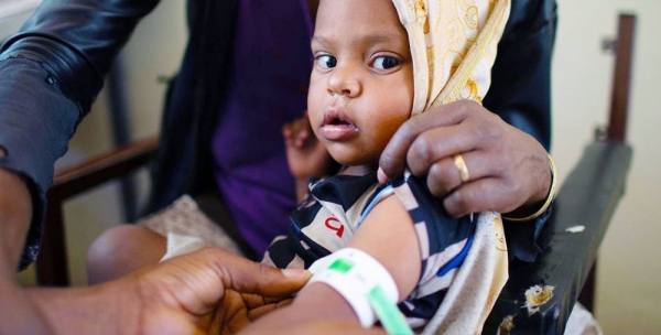 A woman brings her child to a clinic in Wajirat in Southern Tigray in Ethiopia to be checked for malnutrition. — courtesy UNICEF/Christine Nesbitt