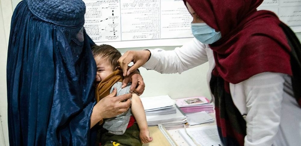 A health worker cares for a young boy in Parwan Province, Afghanistan in November 2020. — courtesy WFP/ Massoud Hossaini