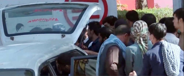 Afghans are seen taking the bodies of the killed relative in the Kabul Airport blasts. Reports on Friday raised the overall death toll from Thursday's attack to at least 169.