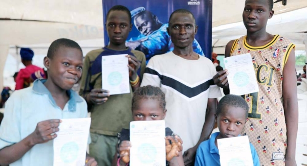 Children at a camp for displaced people in Nigeria receive birth certificates, an important document to proved their nationality. — courtesy UNHCR/Gabriel Adeyemo