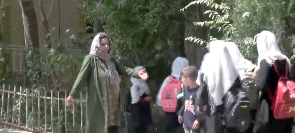 Videograb of a schoolteacher with Afghan girls attending schools.