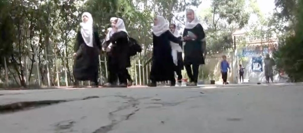 Videograb of a schoolteacher with Afghan girls attending schools.