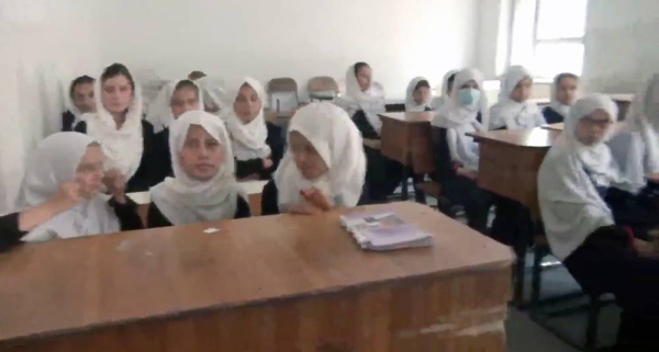 Videograb of a schoolteacher with Afghan girls attending schools.