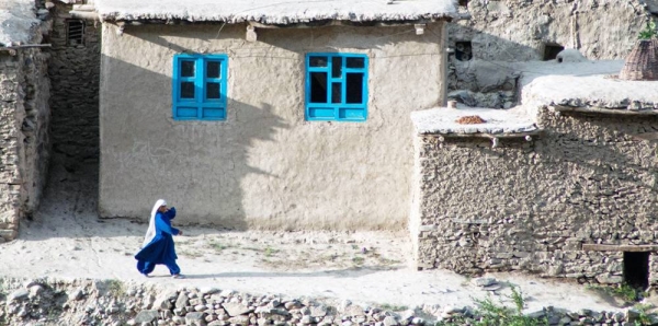 A woman walks in Badakhshan, a province located in northeastern Afghanistan. — courtesy Unsplash/Joel Heard