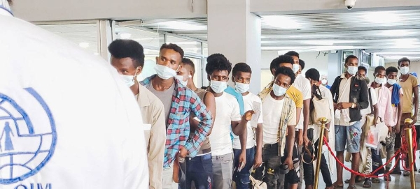 Migrants line up at the airport in Aden, Yemen, for a flight which will take them to Ethiopia. — courtesy IOM/Majed Mohammed