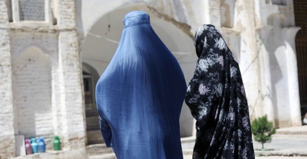 Two Afghan women walk near an ancient mosque in western Herat province. — courtesy UNAMA