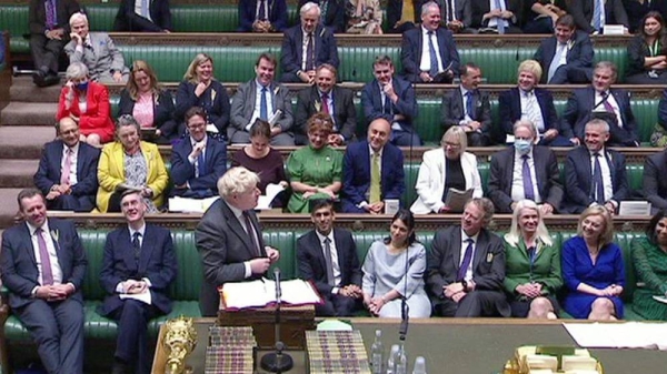 UK Premier Boris Johnson speaks with the government front bench watching. — courtesy photo
