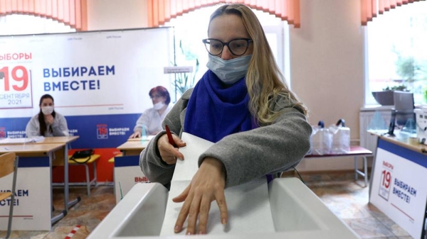 A Russian voter is seen casting her ballot. Millions of Russians cast their vote this weekend in a general election expected to bring little political change.