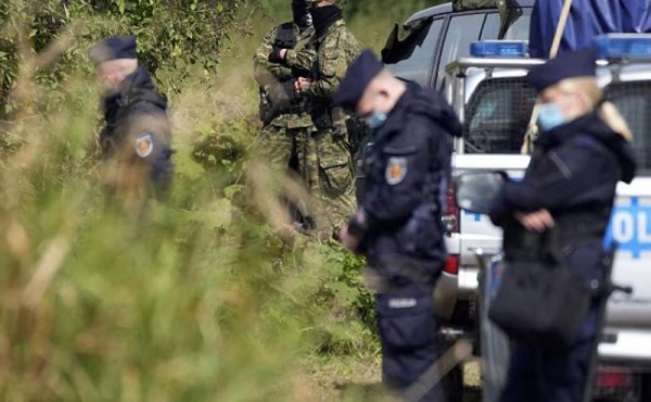 Polish forces stand guard in an area near the border with Belarus.