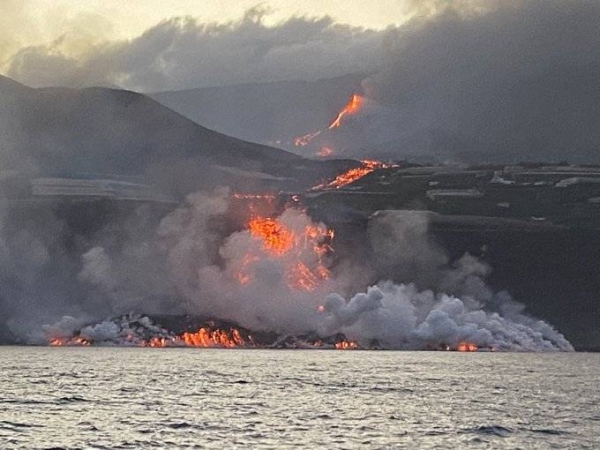 Clouds of steam can be seen as scorching lava enters the Atlantic Ocean