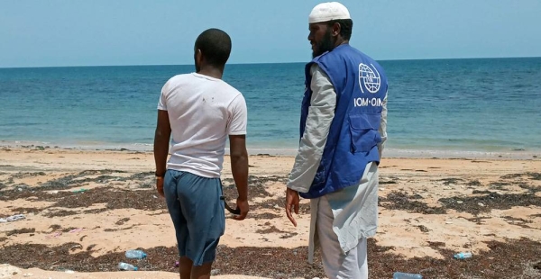 A staff member of the IOM in Djibouti talks to a migrant who arrived in the African country by boat. — courtesy IOM 2021/Abdallah Mohamed