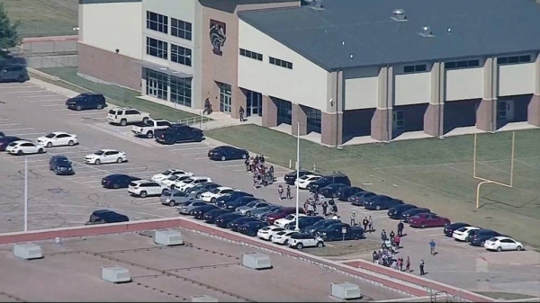 A view of students leaving the school in an orderly manner after a gunman had fired shots in Timberview High School in Arlington, Texas.