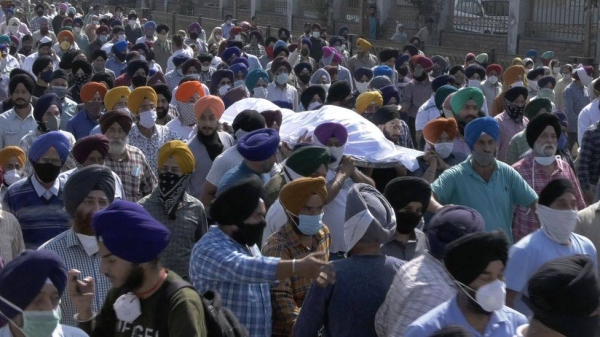 Relatives of slain government school principal Supinder Kour mourns during a funeral procession in Srinagar on October 8, 2021.