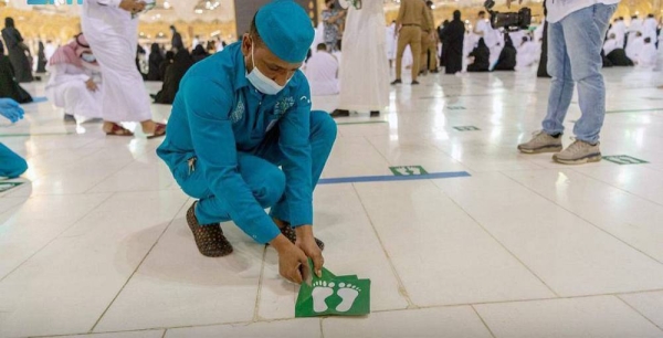 Workers have begun removing social distancing stickers from indoor and outdoor corridors, squares and facilities of the Grand Mosque.