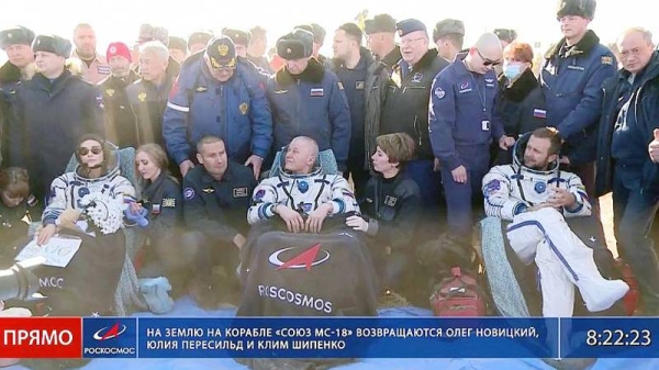 Russian space agency cosmonaut Oleg Novitskiy, center, actress Yulia Peresild, left, and film director Klim Shipenko sit in chairs shortly after landing in Kazakhstan. — courtesy Roscosmos Space Agency