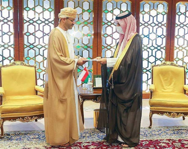 Prince Faisal Bin Farhan, Minister of Foreign Affairs, being handed the letter Monday by Omani Foreign Minister Sayyid Badr Bin Hamad Bin Hamoud Al-Busaidi during a meeting Monday.