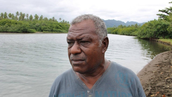 Simione Botu, chief of Vunidogoloa village in Fiji, looks out over the sea from a beach where his childhood home once stood.