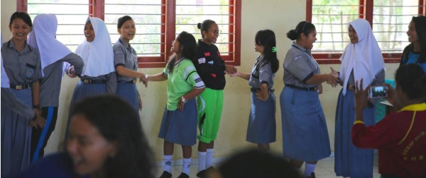 Pupils sing a song as part of a tolerance workshop at a school in Indonesia.