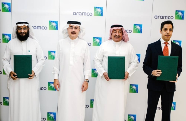 Aramco President and CEO Amin H. Nasser, center, over sees the MoUs signed by Aramco Tuesday as it plans to expand its focus on emerging sectors to drive private sector innovation and investment.