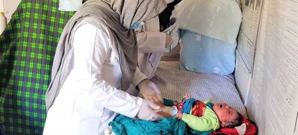 A midwife at a family health house in Daikundi, Afghanistan, provides care to a baby (file photo).