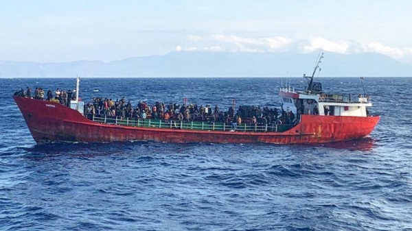 This photo provided by the Hellenic Coast Guard and taken from a vessel shows a ship with migrants near the southern island of Crete, Greece, on Friday, Oct. 29, 2021.