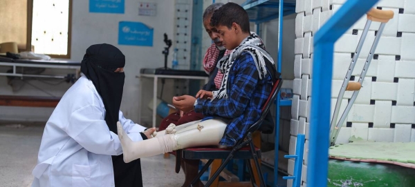 A doctor checks a young boy’s artificial limbs at a hospital in Aden, Yemen.
