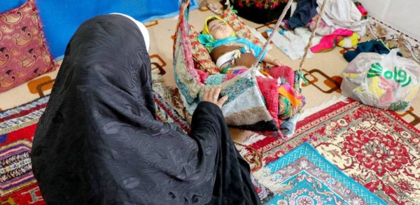 A mother of six tends to her youngest child in Khorasan Province in Iran. — courtesy UNICEF Iran/Mehdi Sayyari