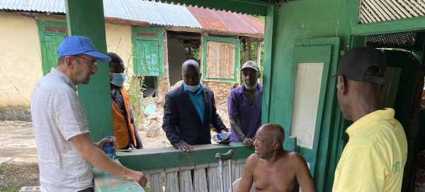 Bruno Lemarquis (left) the UN’s Resident and Humanitarian Coordinator in Haiti talks to people affected by the earthquake in southwest Haiti.