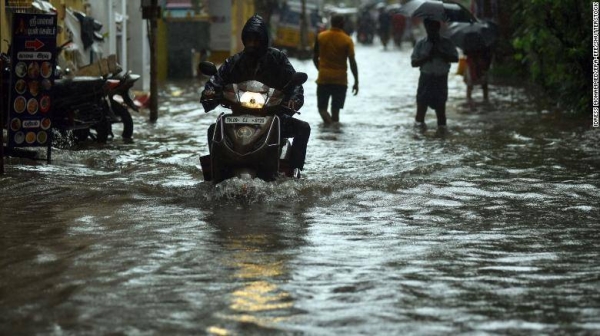 A motorist on a waterlogged road in Chennai, India, as the city flooded from heavy rain.