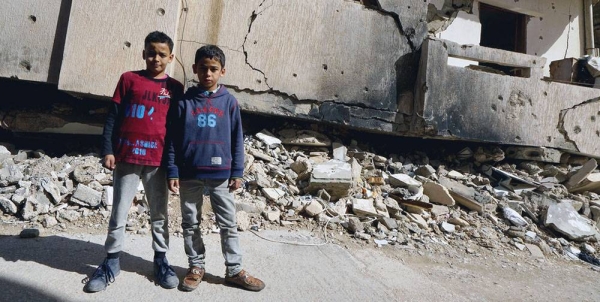 Young boys stand in front of a destroyed building in Benghazi Old Town in Libya. (file). — courtesy UNOCHA/Giles Clarke