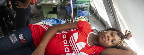 Désir Murielle and her new-born baby boy, Yves, rest in a tented maternity ward.