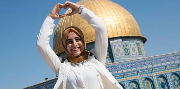 A Palestinian girl who left the West Bank for the first time stands outside the Dome of Rock in Jerusalem. — courtesy UNICEF/Ahed Izhiman