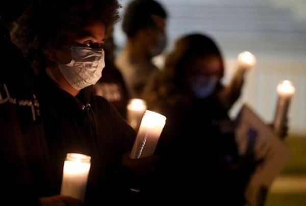 Residents of the Villa Parke neighborhood gather for a candlelight vigil for Iran Moreno, 13, who was killed Saturday night at home in Pasadena. — LAT