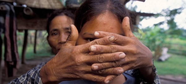 A mother whose daughter was trafficked at the age of 16 covers her face to protect her identity.