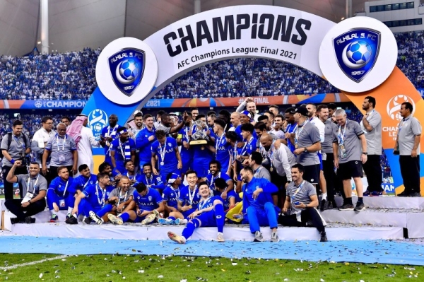 Saudi Arabia's Al Hilal soccer team players celebrate their trophy of the  AFC Champions League 2021 after the team beats South Korea's Pohang  Steelers 2-0 during their final soccermatch at the King