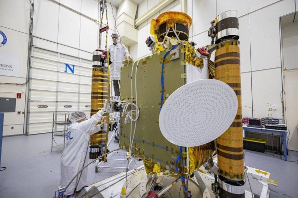 Dart team members inspect the spacecraft's solar arrays back in August.
