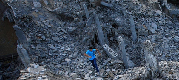 A boy runs in the ruins of the Bab al-Aziziyah compound in Tripoli, Libya.