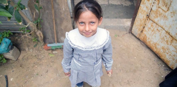 A girl stands in front of her home in Khan Younis Palestine refugee camp in Gaza. — courtesy UNRWA/Hussein Jaber