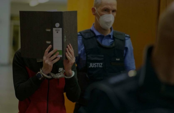 The Iraqi Taha Al-Jumailly is led into the courtroom before the verdict is pronounced in Frankfurt, Germany, Nov. 30, 2021.