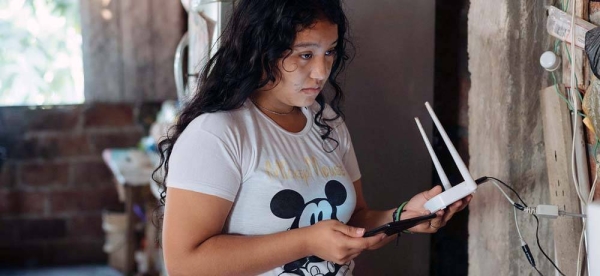 A teenage girl prepares to take part in a virtual class at home in Monte Sinaí, Ecuador. Since the onset of the COVID-19 pandemic many children have fallen behind in their learning due to a lack of Internet access. — courtesy UNICEF/Santiago Arcos